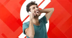 A man laughing in joy after finding the most affordable way to call overseas